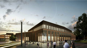 Illustration image set in sunset, depicting Otakaari 2 buildings in the future. People walking around and the lights are on in the building.