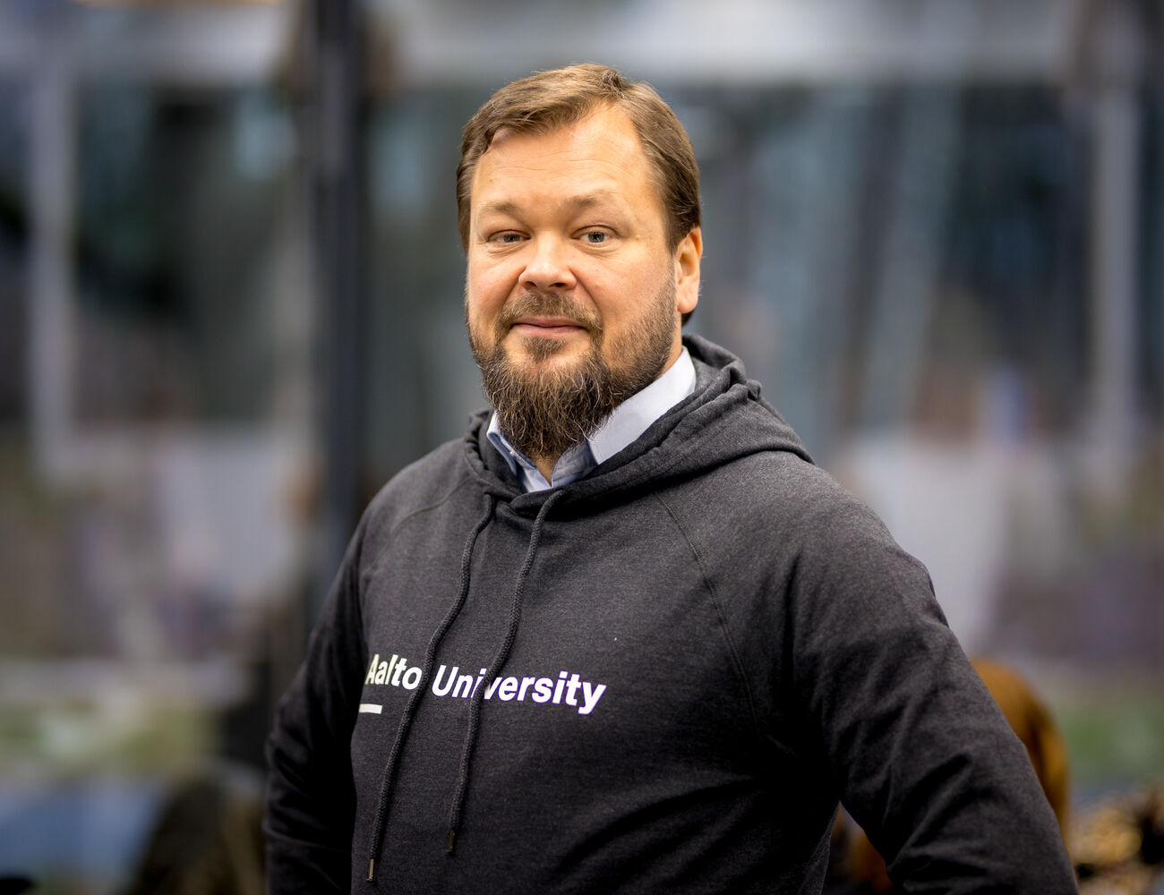 Ville Jokela Aalto CRE Managing Director smiling to the camera, wearing Aalto University hoodie. Pic: Kalle Kataila / Aalto University